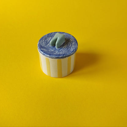 La boîte à dent rayée jaune